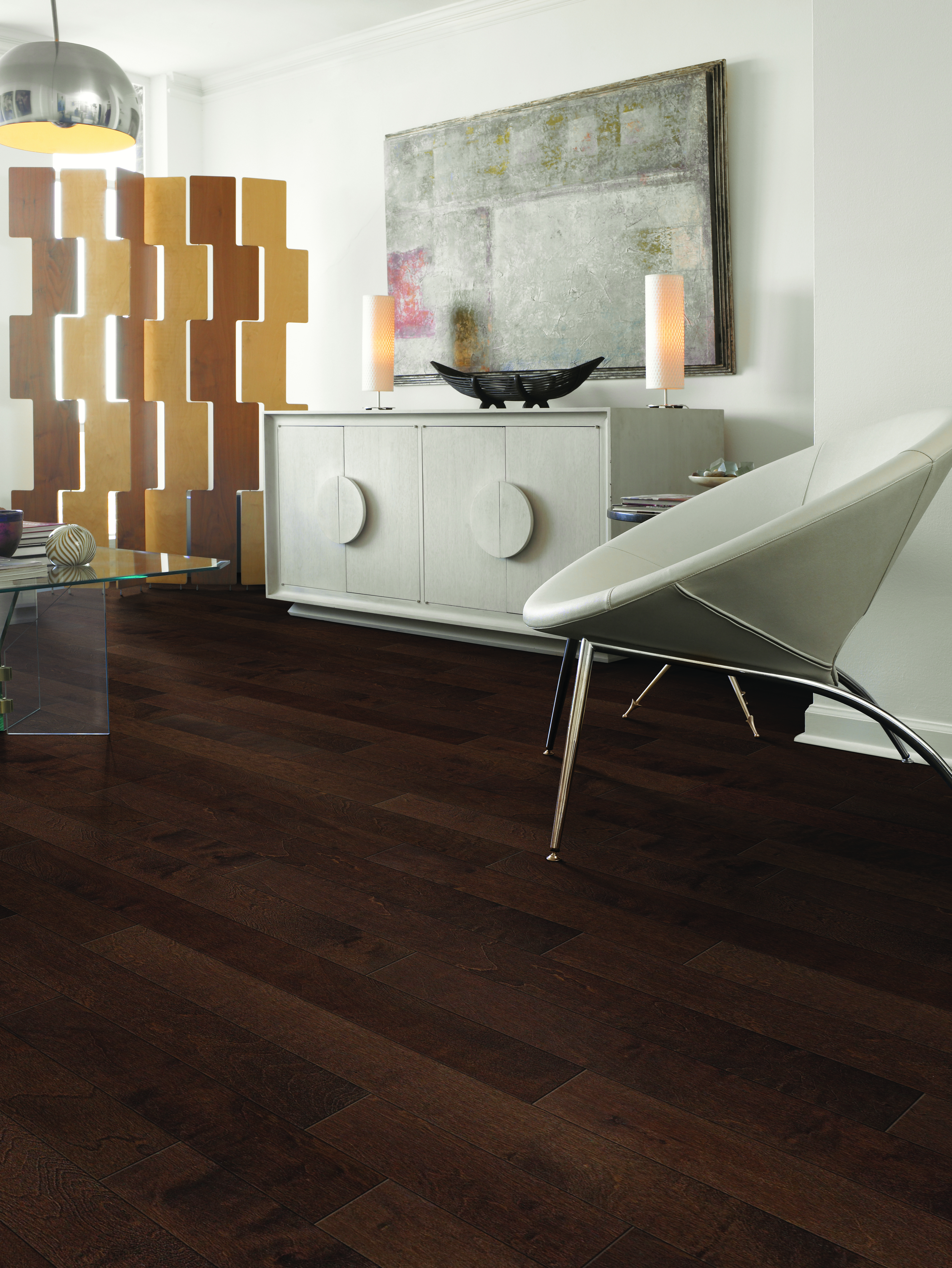Contemporary living space with dark hardwood flooring, modern furniture, and stylish decor accents.