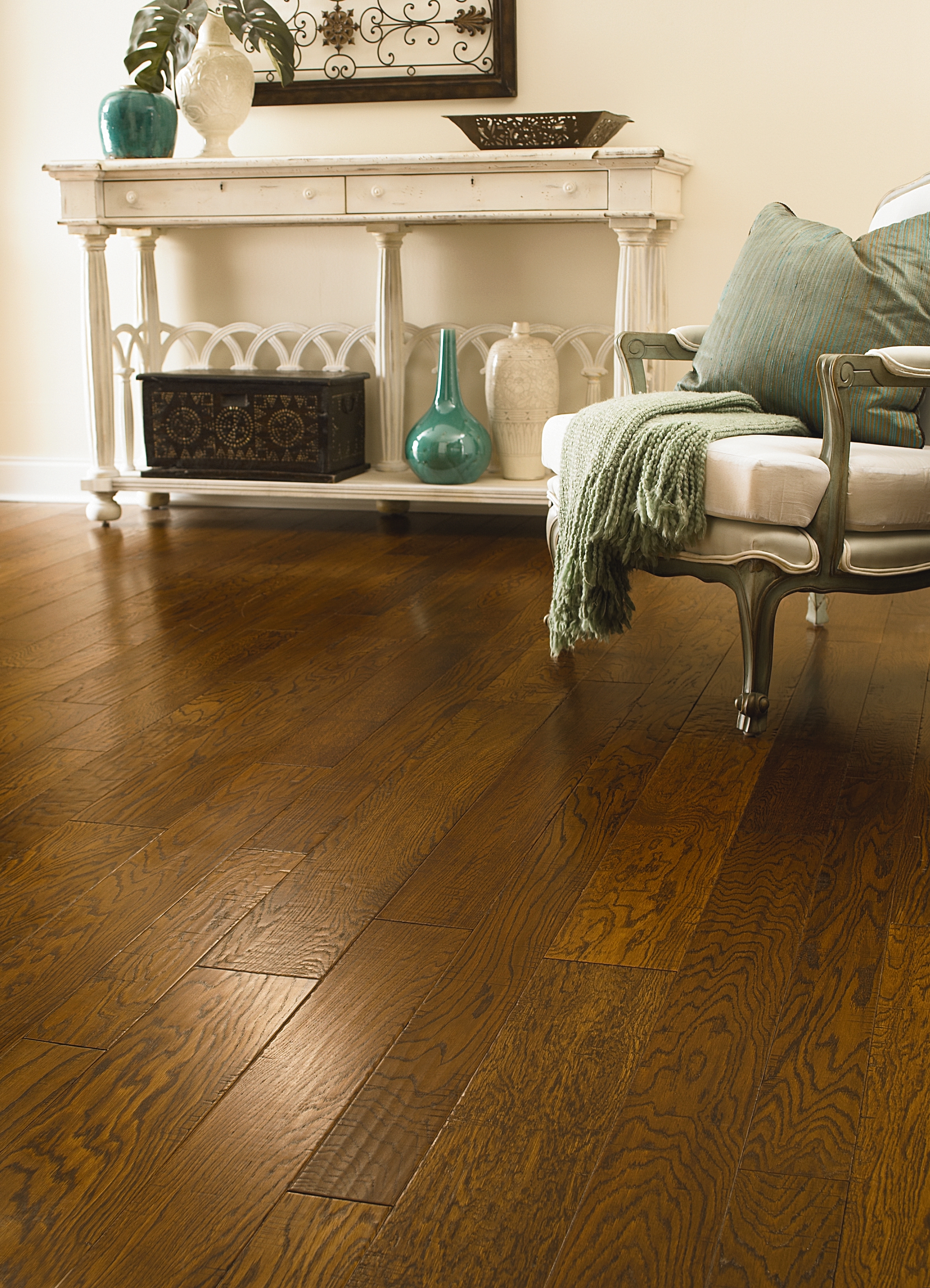 Elegant living room with rich hardwood flooring, antique furniture, and decorative accents for a timeless design.